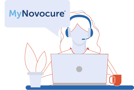 Smiling healthcare coordinator talking on phone and using laptop in modern office